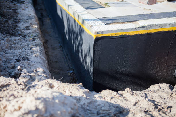 Professional Waterproofing technician working in Medford, NY